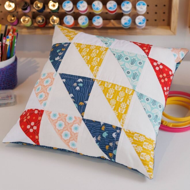 Elevate Your Space with the Enchanting Half Square Triangle Quilted Pillow